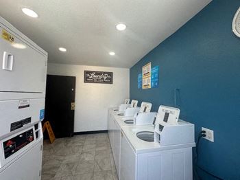 a laundry room with a bunch of washing machines